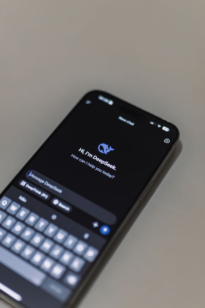 The Art of Drawing Readers In: Your attractive post title goes here Close-up of smartphone screen showing AI chatbot interface, featuring DeepSeek AI conversation.